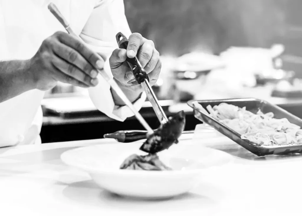 A picture of a private chef preparing a meal for the wedding guests.