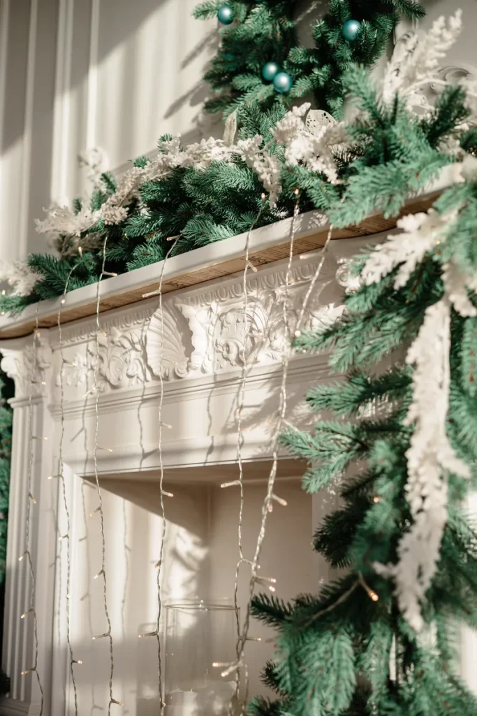 A festive fireplace mantled covered in garlands and Christmas lights.