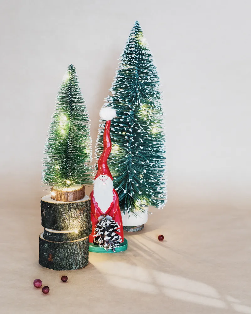 A picture of some bottle brush Christmas trees and a mini Santa.