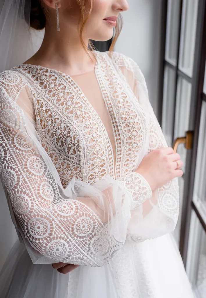 A beautiful lacy sleeved wedding dress.