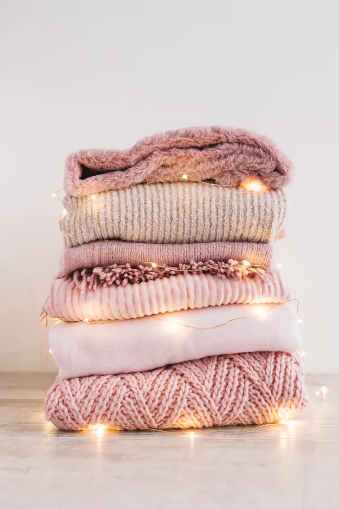 A bunch of light pink cozy blankets.