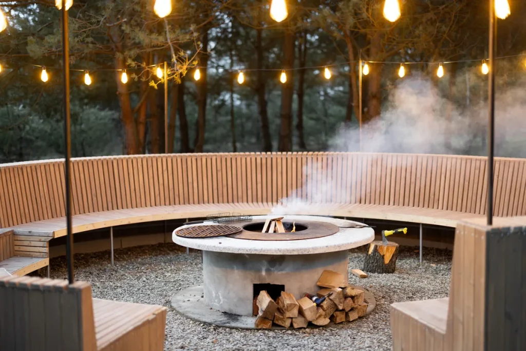 An outdoor firepit with a lovely round seating area around it.