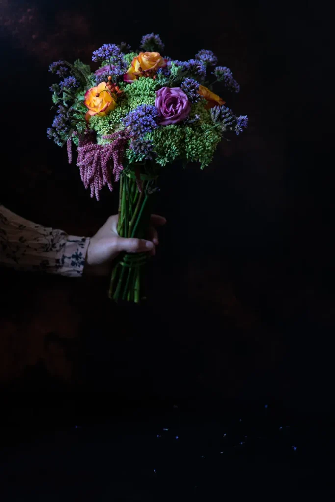 A bouquet of dark flowers and greenery.