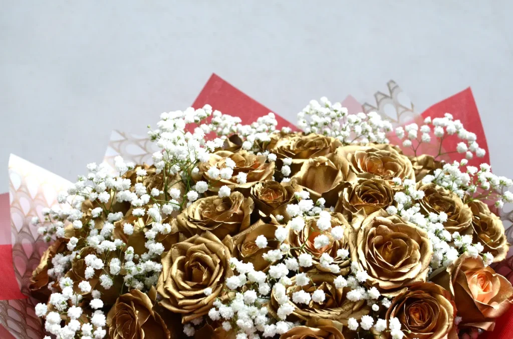 A bouquet of babies breath and gold leaf roses.