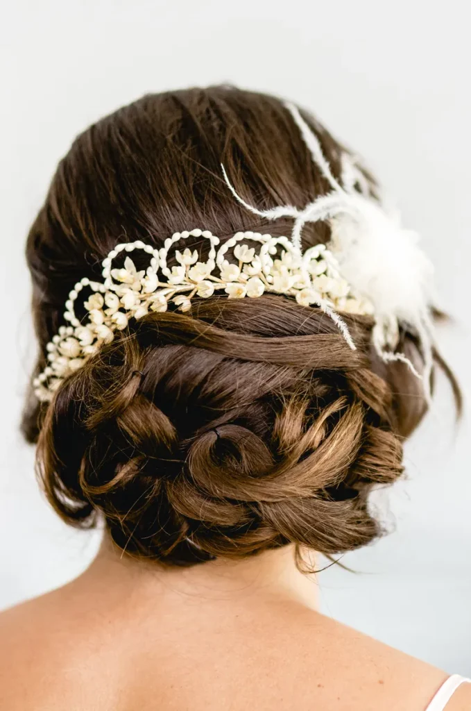A beautiful up-do bun, with a flowery accessory.