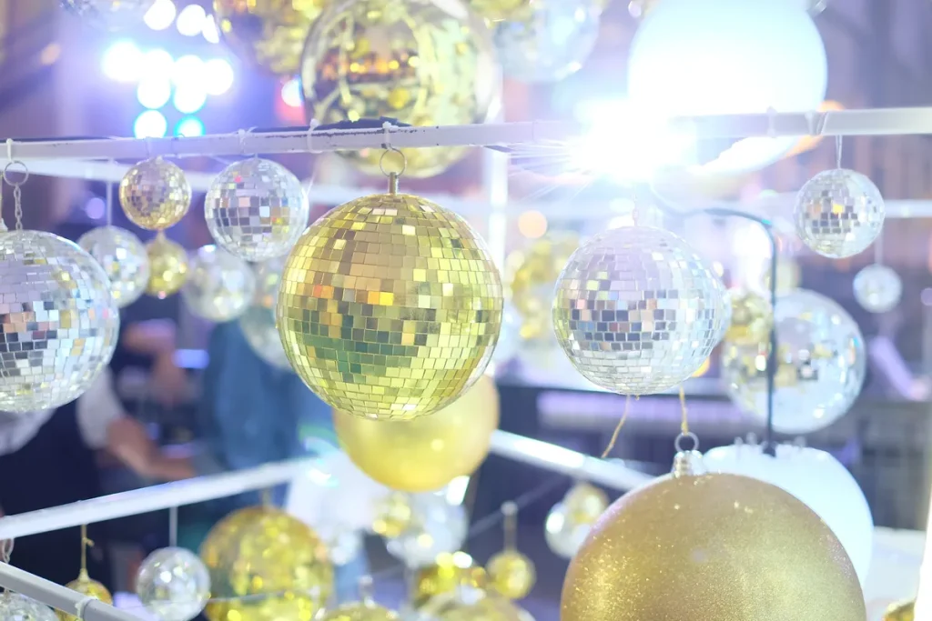 A bunch of disco balls being used as an art installation at a wedding venue.