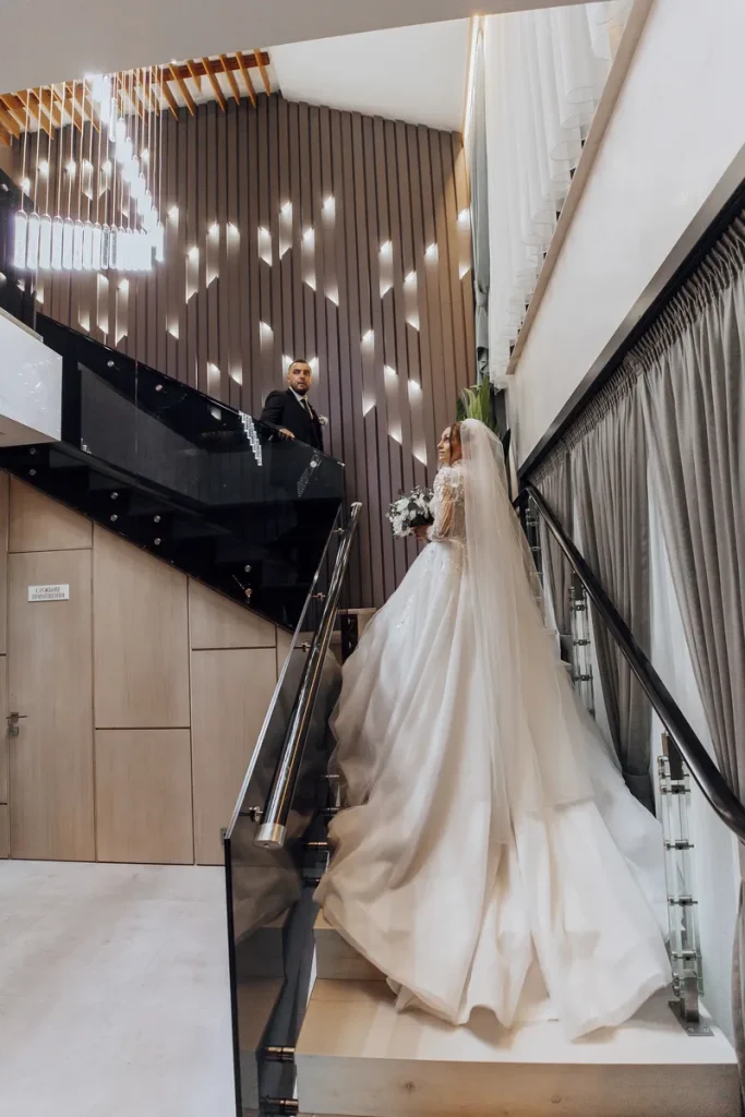 A bride and her groom getting their portrait taken in a modern loft space.
